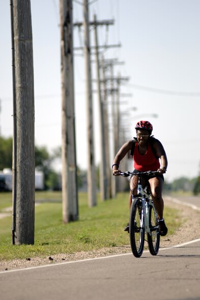 GRAND FORKS AIR FORCE BASE, N.D. ? Dorthea Long pedals the first loop of a 12-mile ride during the base?s first triathlon here, July 28.  The event consisted of a 400-meter swim, 12-mile bike and 5K run. In all, more than 40 participants entered the competition. All finished. (U.S. Air Force photo/Senior Airman J. Paul Croxon)