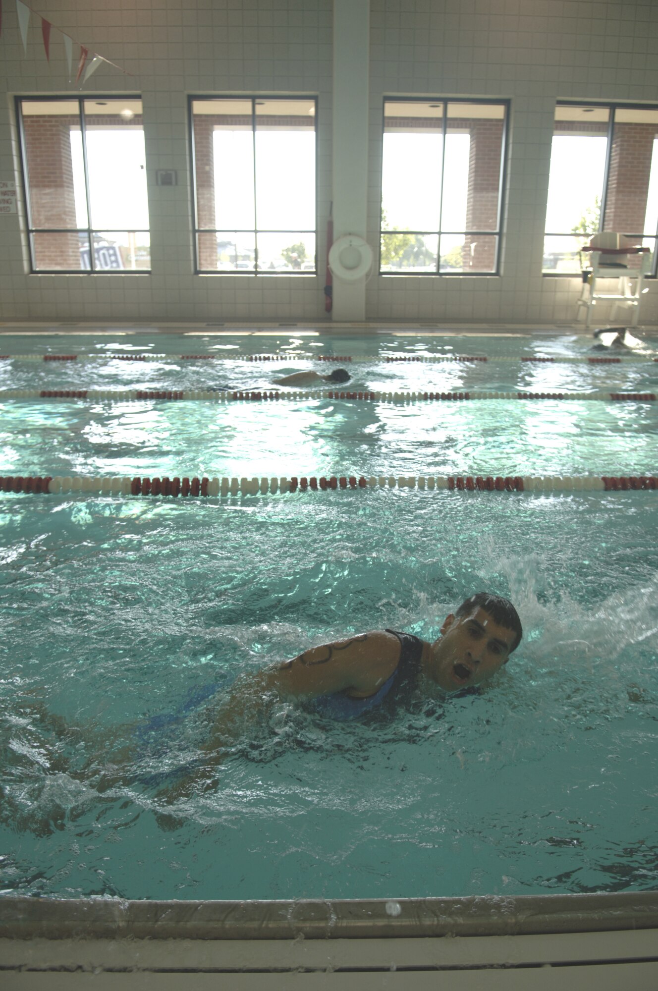 GRAND FORKS AIR FORCE BASE, N.D. --Senior Airman Angel Romero, takes a momentary breath before continuing the 400-meter swim during the base?s first triathlon July 28. Airman Romero is training for the Olympics as a sprinter. The triathlon was a good change of pace from his normal training regimen. (U.S. Air Force photo/Senior Airman J. Paul Croxon)
