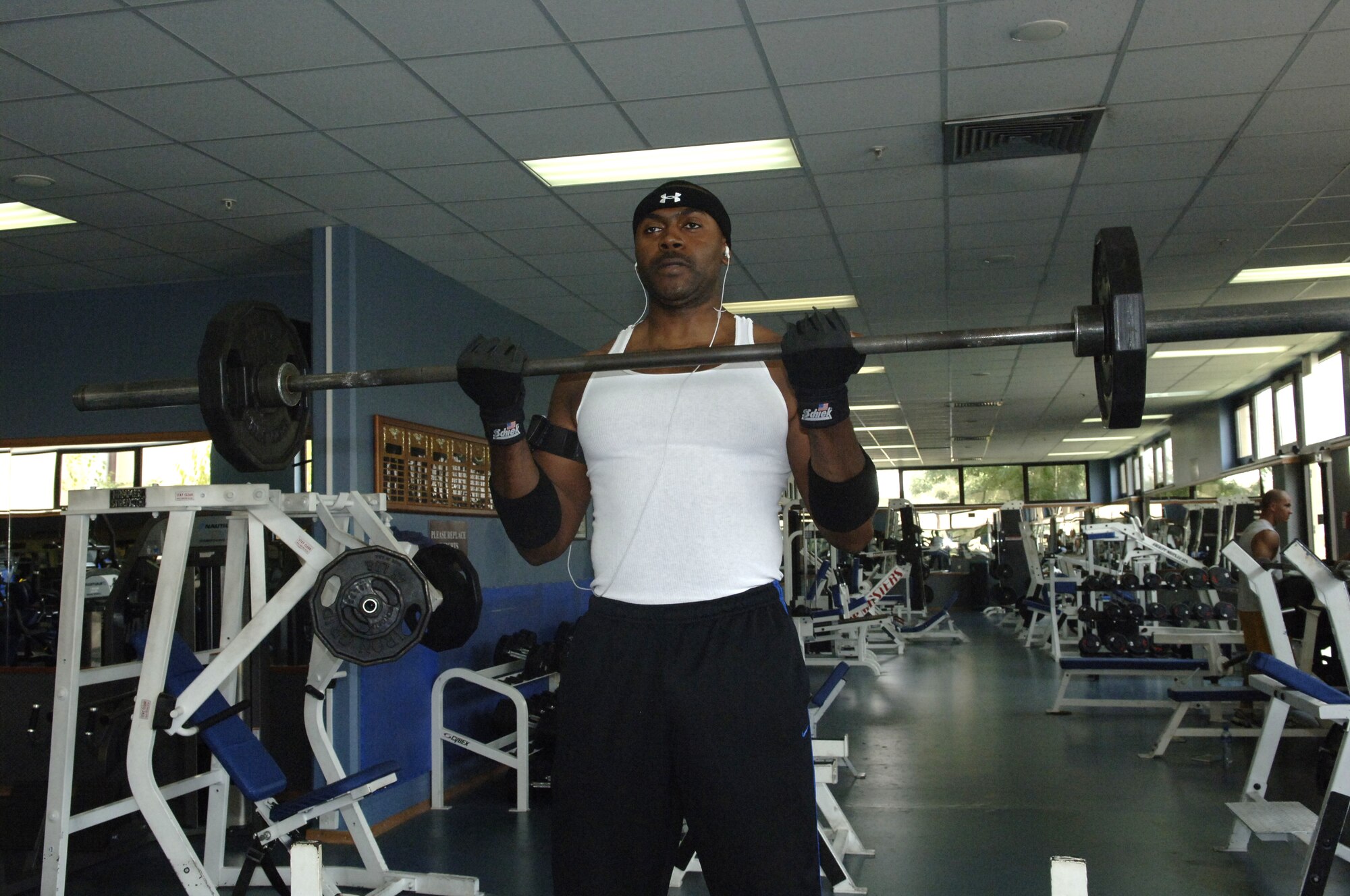 Staff Sgt. Mark Jackson, 728th Air Mobility Squadron ramp services, works out at the fitness center during the afternoon to beat the heat. (U. S. Air Force photo by Airman 1st Class Tiffany Colburn) 