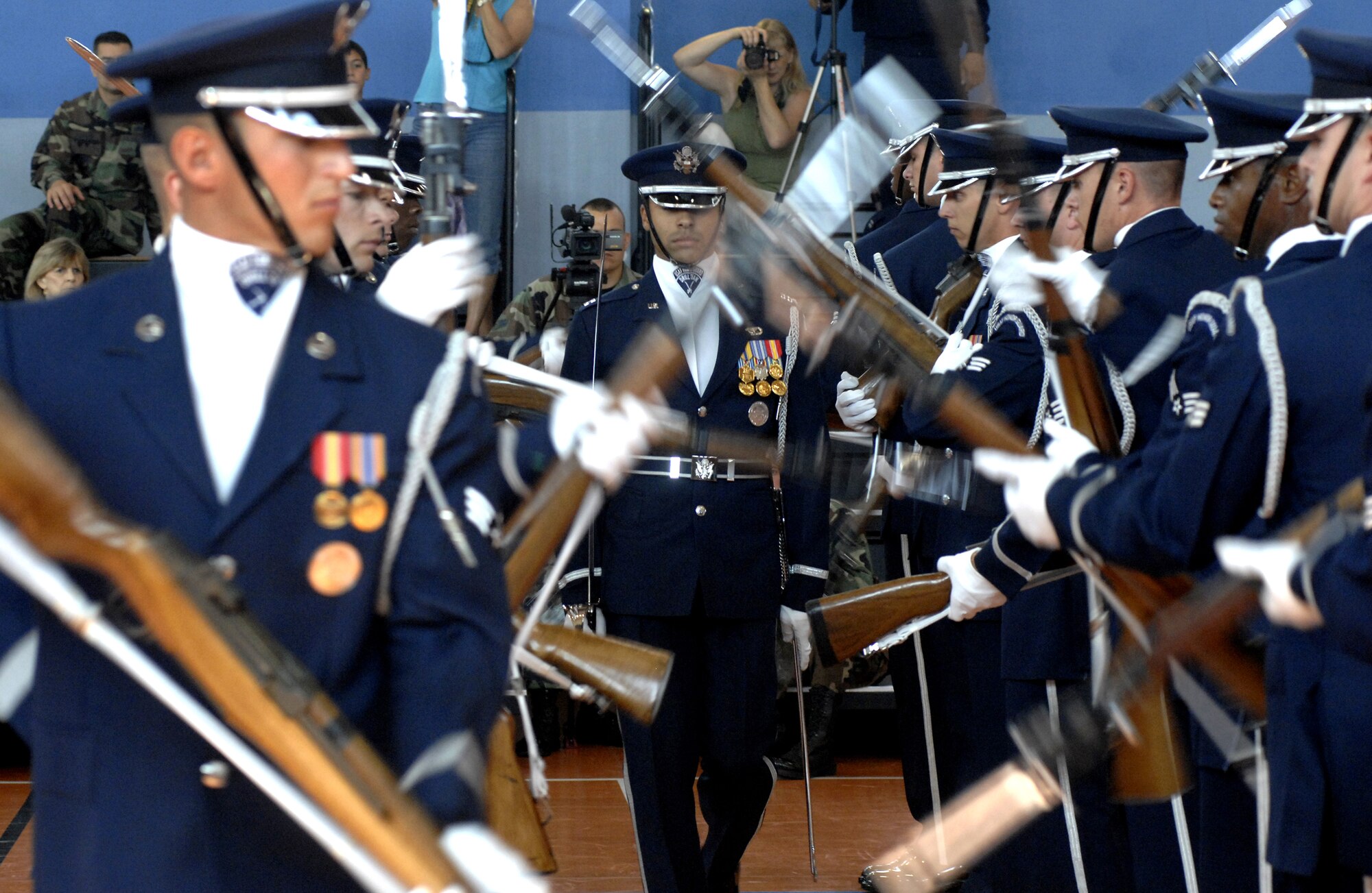 The U.S. Air Force Honor Guard Drill Team performs for youth at the Aviano Youth Center gym Monday. The team consists of current honor guard members throughout the Air Force. Their performance included weapons manuevers, tosses, complex weapons exchanges and a walk through  spinning weapons. For more information on the team, visit http://www.honorguard.af.mil/drillteam. (Photo by Airman 1st Class Liliana Moreno)