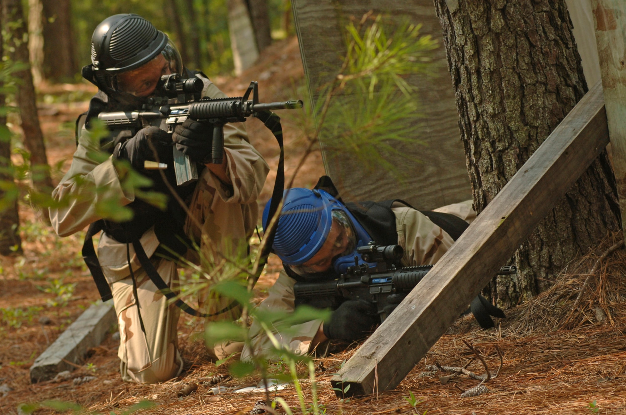 Staff Sgts. Jeremy Thomas and Joshua Rance, 437th Security Forces Squadron expeditionary combat skills training instructors, test the new protective gear in action as they aim and fire simunition rounds at the opposing team July 27 on Charleston AFB. (U.S. Air Force Photo/Staff Sgt. April Quintanilla)