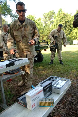Staff Sgt. Jeremy Thomas, 437th Security Forces Squadron expeditionary combat skills training instructor, loads his weapon with new Simunition amunition prior to dawning the new protective gear to test the equipment July 27 on Charleston AFB. (U.S. Air Force Photo/Staff Sgt. April Quintanilla)