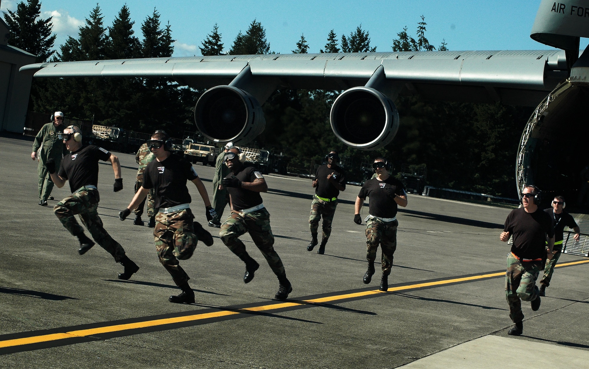 Members of the Patriot Wing?s aerial port Air Mobility Rodeo team participate in the C-5 engines running offload (ERO) competition at McChord Air Force Base, Wash. The Westover team won first place for the best C-5 ERO team in the Air Force. (U.S. Air Force photo/Tech Sgt. Andrew Biscoe)