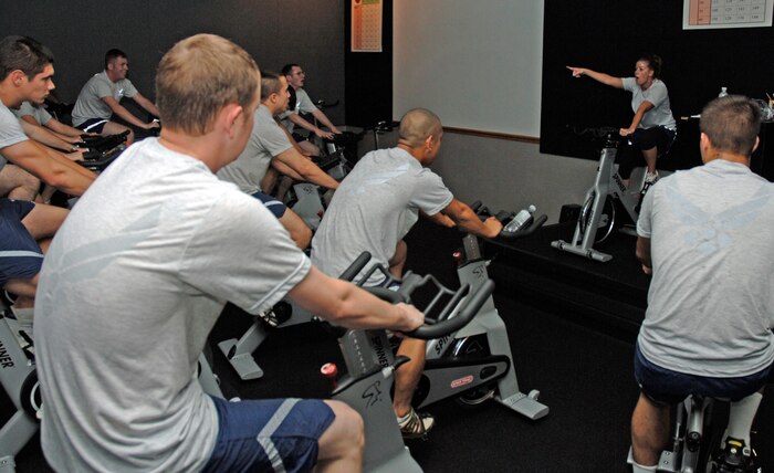 Jennifer Kindernay, 437th Mission Support Squadron NCO in charge of First Term Airmen Center, motivates her FTAC class to keep going during their spinning session at the base Fitness and Sports Center Tuesday. (U.S. Air Force Photo/Staff Sgt. April Quintanilla)