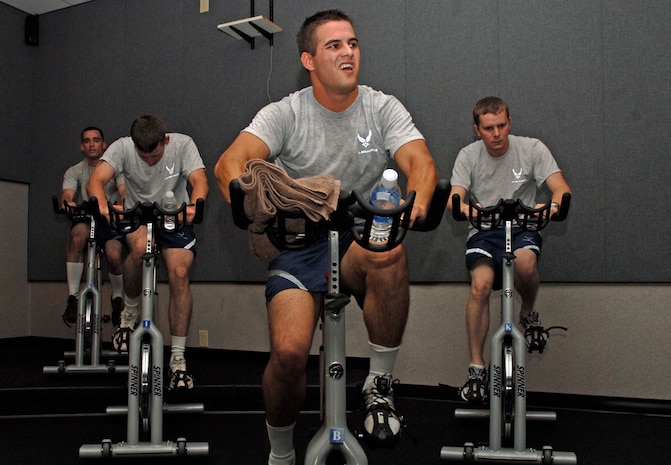 Joseph Pears, 437th Aerial Port Squadron, Joseph Dooley, 437th Maintenance Squadron, David Rose, 437 MXS, and Don Rudd, 437 APS, push through a scheduled physical training spin session. (U.S. Air Force Photo/Staff Sgt. April Quintanilla)
