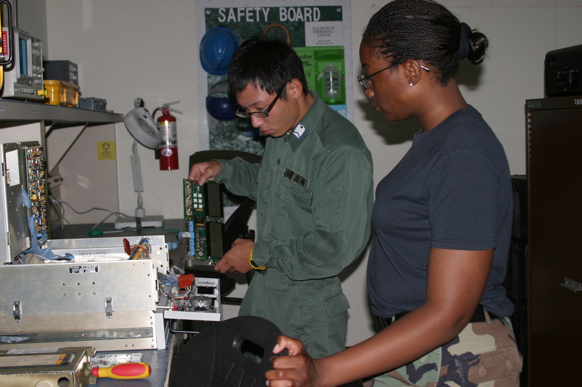 Japan Air Self Defense Force Staff Sgt. Youki Takasaki, from Okinoerabu-Jima Air Station, helps Senior Airman Alysha Landers, 18th Communications Squadron, repair a radio unit July 25. Seven JASDF military members recently took part in an exchange program where each member was paired with a Kadena sponsor, allowing them to spend time together and learn how their respective country’s military does business.
(U.S. Air Force/Senior Airman Nestor Cruz)