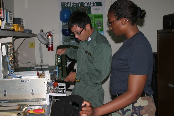 Japan Air Self Defense Force Staff Sgt. Youki Takasaki, from Okinoerabu-Jima Air Station, helps Senior Airman Alysha Landers, 18th Communications Squadron, repair a radio unit July 25. Seven JASDF military members recently took part in an exchange program where each member was paired with a Kadena sponsor, allowing them to spend time together and learn how their respective country’s military does business.
(U.S. Air Force/Senior Airman Nestor Cruz)