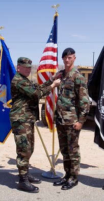 Col. Bryan Gallagher (left), 95th Air Base Wing commander, pins the Bronze Star Medal with Valor to Senior Airman Phillip King, 95th Security Forces Squadron patrolman, during a ceremony Monday at the 95th SFS headquarters. Airman King received the award for his gallantry during a deployment in support of Operation Enduring Freedom. (Photo by Edward Cannon)