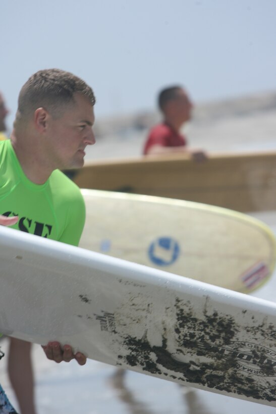 Capt. John Bitonto, the 28-year-old commanding officer for Companies H and I with Infantry Training Battalion, School of Infantry-West, prepares to attack the ocean during a surfing competition on Del Mar Beach Aug. 1.