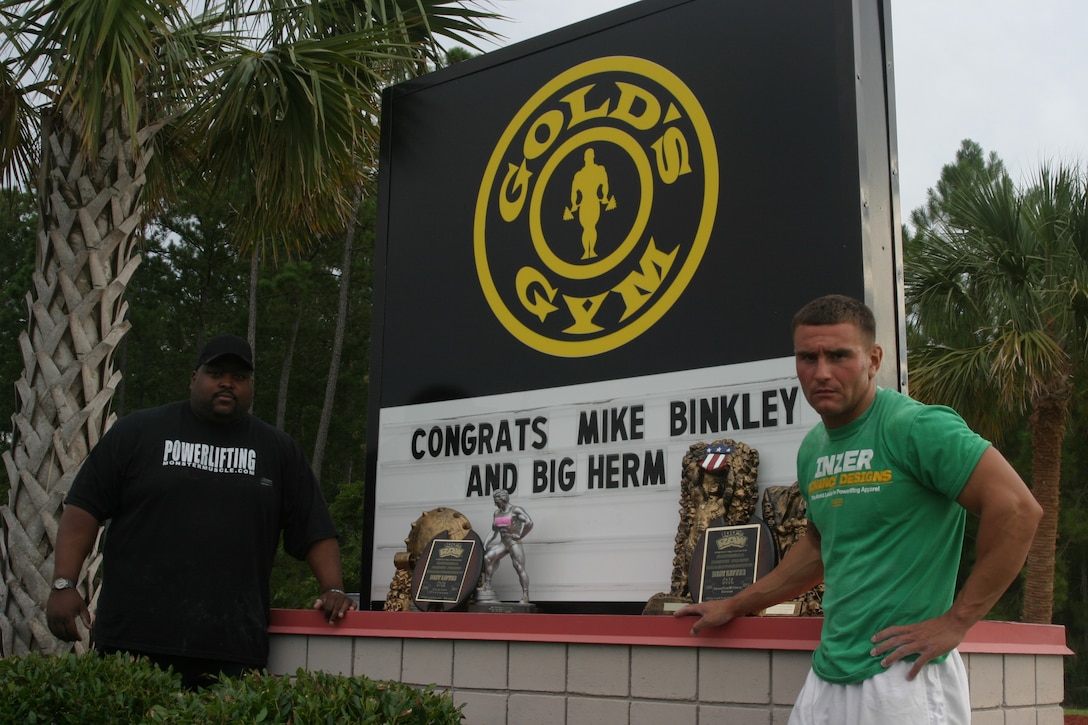 MARINE CORPS BASE CAMP LEJEUNE, N.C. (Aug. 8, 2007) ? Sgt. Michael B. Binkley (right), a scout squad leader with 2nd Light Armored Reconnaissance Battalion, 2nd Marine Division, along with workout partner, Herman ?Big Herm? Canada, stand in front of Jacksonville Gold?s Gym.  Binkley, aided by the help of ?Big Herm?, captured the current police, fire and military bench press world record with a bench press of 365 pounds.