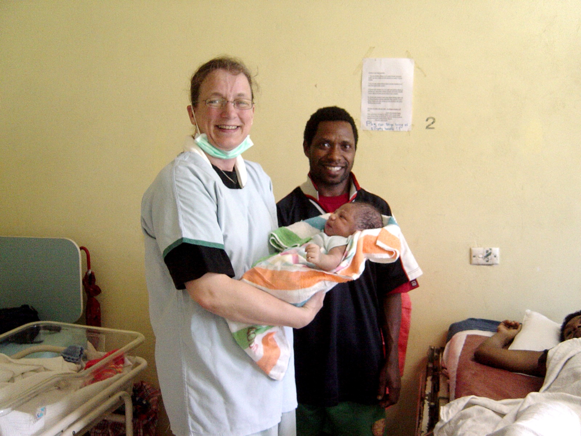 Capt. Christine Crawford, general medical surgical nurse, 3rd Wing, Elmendorf Air Force Base, Alaska, holds a newborn baby at Espiritu Santo hospital in Vanuatu.  Captain Crawford was part of an Obstetrics/Gynecological surgical team which visited Espiritu Santo island in the nation of Vanuatu to train medical staff and perform surgery. The team was part of the Oceania Humanitarian Assistance Mission that brought medical, dental and engineering personnel to perform civil assistance projects on Vanuatu, Nauru and Kiribati July 20-30. (U.S. Air Force Photo)