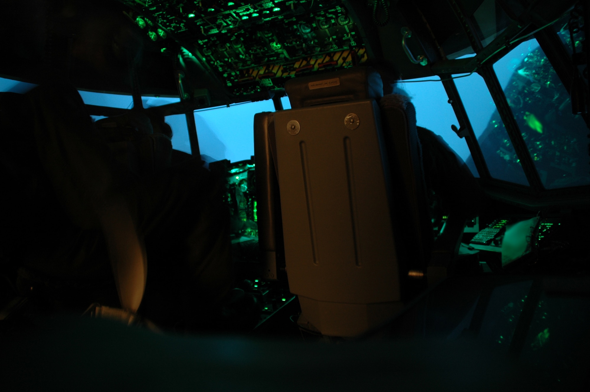 An U.S. Air Force 4th Special Operations Squadron AC-130U crew from Hurlburt Field, Fla., participates in the first joint virtual simulator training with the Marines from 29 Palms, Calif. and Marine Forces Special Operations Command. These two seperate locations trained in real time on convoy escort duty and actively engaged enemy targets from their home station in a mock foreign land.  After 1.5 hours both the Airmen and Marines debrief and started a new exercise allowing both sides to perfect training techniques prior to deploying to fight the Global War on Terrorism.  (USAF photo by Capt. Joseph Coslett) 