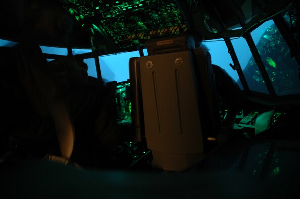 An U.S. Air Force 4th Special Operations Squadron AC-130U crew from Hurlburt Field, Fla., participates in the first joint virtual simulator training with the Marines from 29 Palms, Calif. and Marine Forces Special Operations Command. These two seperate locations trained in real time on convoy escort duty and actively engaged enemy targets from their home station in a mock foreign land.  After 1.5 hours both the Airmen and Marines debrief and started a new exercise allowing both sides to perfect training techniques prior to deploying to fight the Global War on Terrorism.  (USAF photo by Capt. Joseph Coslett) 
