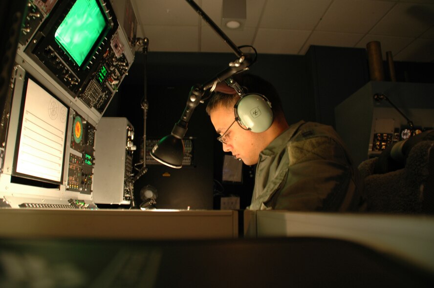 An U.S. Air Force captain, 4th Special Operations Squadron AC-130U electronic warfare officer from Hurlburt Field, Fla., communicates with in real time with Marines during convoy training. He with other crewmembers participate in the first joint virtual simulator training with the Marines from 29 Palms, Calif. and Marine Forces Special Operations Command. These two seperate locations trained in real time on convoy escort duty and actively engaged enemy targets from their home station in a mock foreign land.  After 1.5 hours both the Airmen and Marines debrief and started a new exercise allowing both sides to perfect training techniques prior to deploying to fight the Global War on Terrorism.  (USAF photo by Capt. Joseph Coslett) 