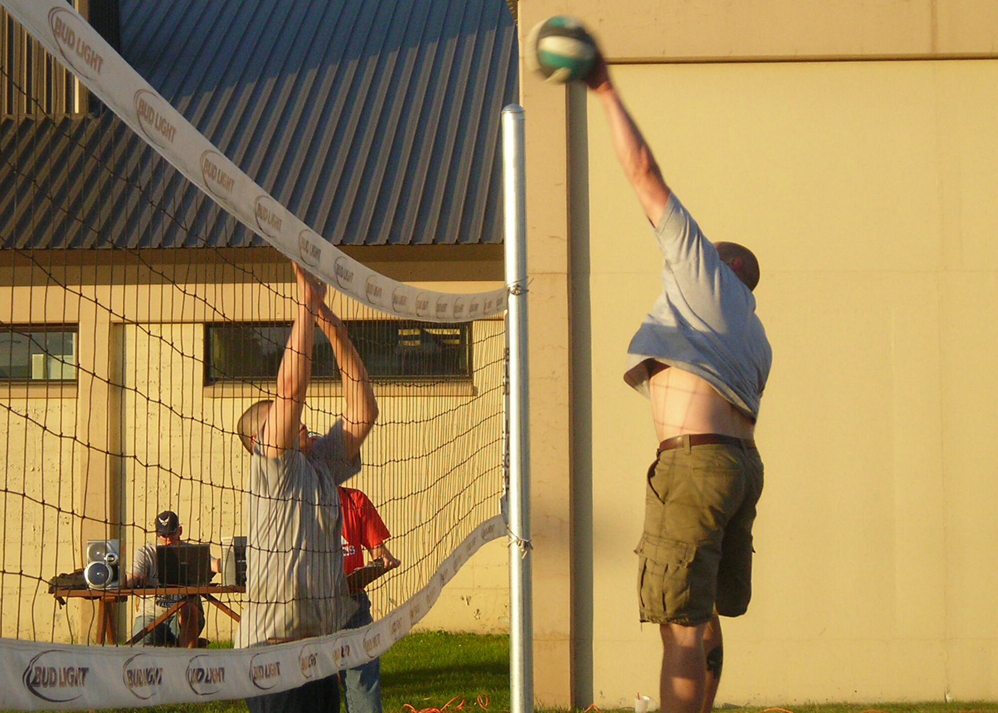 EIELSON AIR FORCE BASE, Alaska?Airman 1st Class Charlie Wilcox, 354th Maintenance Squadron, jumps to spike the volleyball against Senior Airman Dominic Garcia, 354th Communication Squadron, in the BASE 24/7 Volleyball Tournament July 28 at the Yukon Club. Teams from each 354th Fighter Wing group competed for the BASE 24/7 traveling trophy; for this tournament, the 354th Medical Group took it home. The game was sponsored by the 354th Maintenance Group. (U.S. Air Force photo by Lt. Col Patrick Reese)           