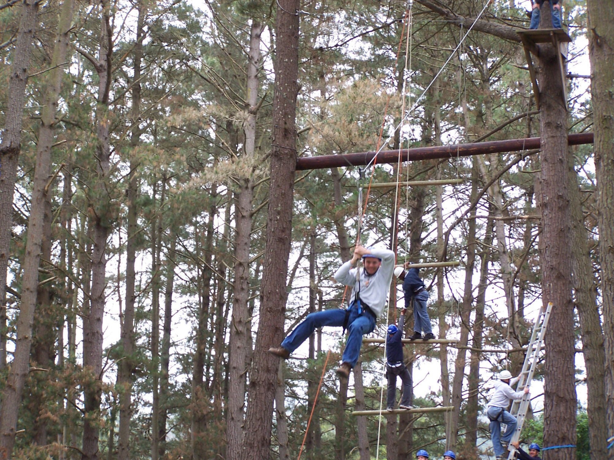 Master Sgt. Michael Ammons, 341st Medical Group first sergeant, slides through treetops during a ropes course teamwork exercise In May. The Air Force master sergeant attended the Coast Guard's Chief Petty Officer Academy in Petluma, Calif., in lieu of the Air Force's Senior NCO Academy required for his professional military education. (U.S. Air Force photo)