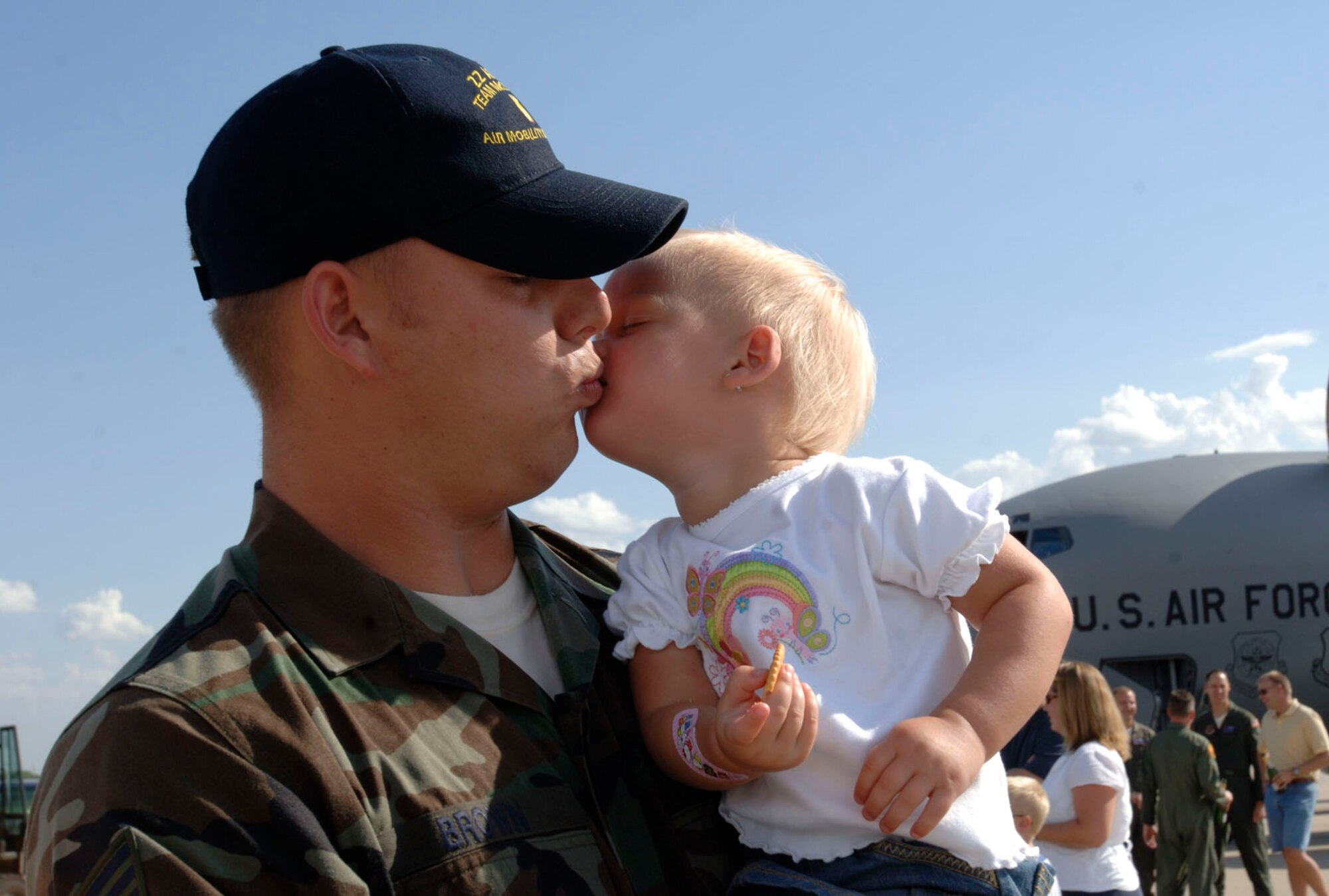 MCCONNELL AIR FORCE BASE, Kan. -- Staff Sgt. Tim Brown, 22nd Aircraft Maintenance Squadron, kisses his daughter, Maddison, 2, after returning to McConnell Jul 28from a Rodeo competition. Rodeo 2007, hosted by Air Mobility Command, was a readiness competition that ran July 22-28 at McChord Air Force Base, Wash., The competition included U.S. and international mobility forces. It focuses on improving warfighting capabilities and support of the global war on terrorism. (Photo by Tech Sgt. Chyrece Campbell)