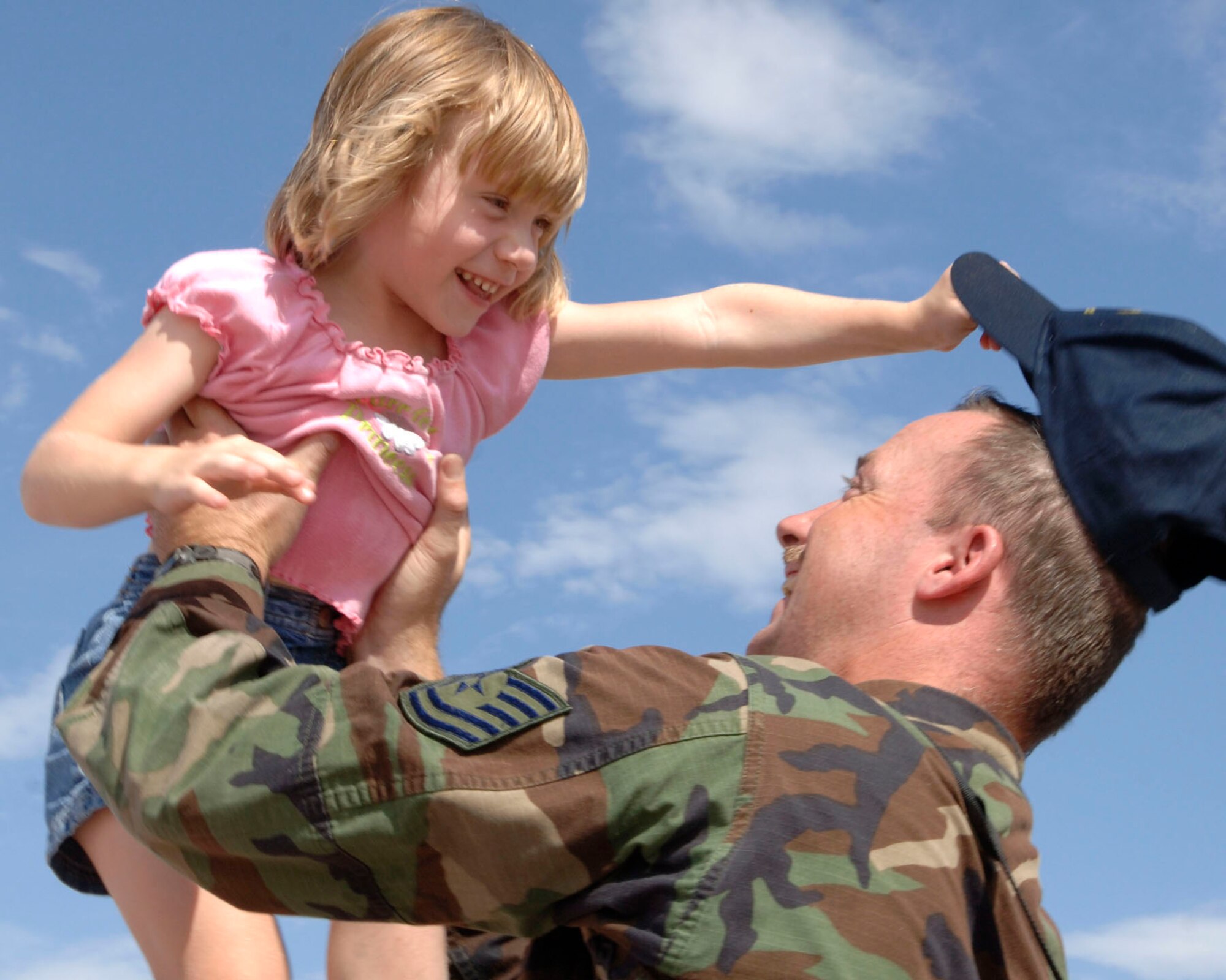 MCCONNELL AIR FORCE BASE, Kan. -- Tech. Sgt. Christopher Blachford, 22nd Aircraft Maintenance Squadron, lifts his daughter, Allison, 4, after returning to McConnell Jul 28 from a Rodeo competition. Rodeo 2007, hosted by Air Mobility Command, was a readiness competition that ran July 22-28 at McChord Air Force Base, Wash., The competition included U.S. and international mobility forces. It focuses on improving warfighting capabilities and support of the global war on terrorism. (Photo by Tech Sgt. Chyrece Campbell)