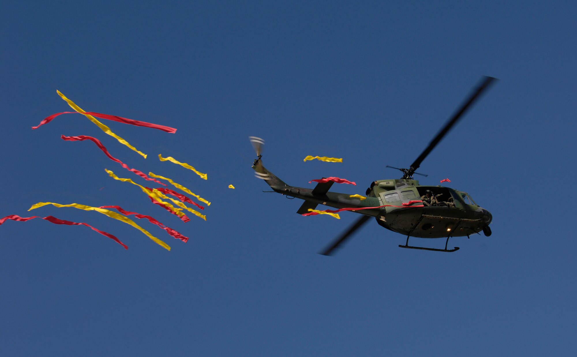 VANDENBERG AIR FORCE BASE, Calif. -- A UH-1N helicopter from the 76th Helicopter Squadron drops steamers during its final flight at Vandenberg on July 31. The helicopter is scheduled to be reassigned to F.E. Warren AFB following the inactivation of the 76th HS during a ceremony at the hangar at 10 a.m. on Aug. 2.  The ceremony brings a 49-year era of helicopters at Vandenberg to a close. (U.S. Air Force photo/Airman 1st Class Christian Thomas)