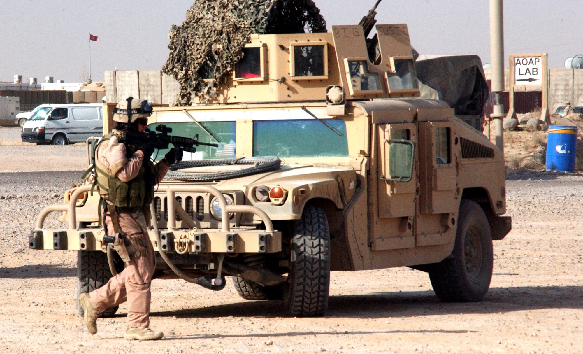 Staff Sgt. Aaron Downing secures the area around a Humvee during "battle drills" performed before each mission at Contingency Operating Base Speicher, Iraq. Sergeant Downing performs duties on a Police Transition Team here, and the drills are designed to simulate any possible situation the team may encounter while conducting missions outside the wire. The PTT's goal is to help the Iraqis establish a functioning, independent police force. Sergeant Downing is assigned to the 732nd Expeditionary Security Forces Squadron Det 1. (U.S. Air Force photo/Master Sgt. Steve Horton) 
