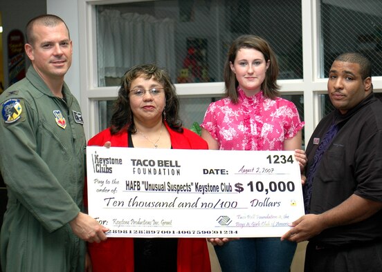 Mr. Mario Sweet, manager of the local Taco Bell franchise, presents Col. Michael McGee, 49th Fighter WIng vice commander, Ms. Matrice Adger, Keystone Club advisor, and Tamatha Hampton, Keystone Club president, a check for $10,000 from the Taco Bell Foundation. The money was granted to the Keystone Club for a project they submitted. The Keystone Club purchases an indoor/outdoor Airscreen Entertainment System with the grant and will use it as an entrepreneurial project. (U.S. Air Force photo/Airman 1st Class Heather Stanton)