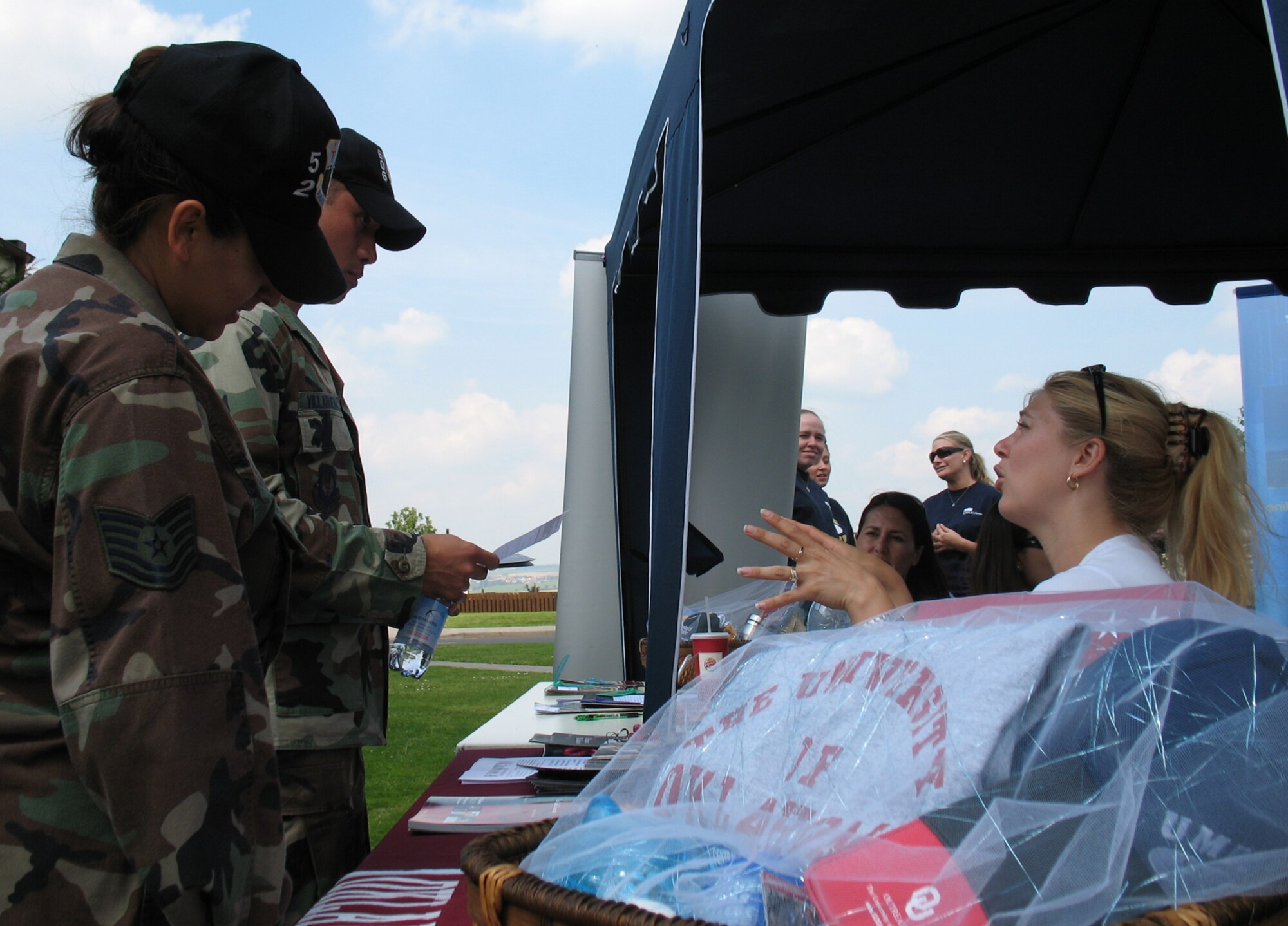 SPANGDAHLEM AIR BASE, Germany – Tech. Troy Margie Quicanopalacios, 52nd Medical Support Squadron, and 1st Lt. Rommel Rommel Villanueva, 606th Air Control Squadron, learn about the masters programs offered by the University of Oklahoma at an education fair Aug. 3. (US Air Force photo/Staff Sgt. Tammie Moore)
