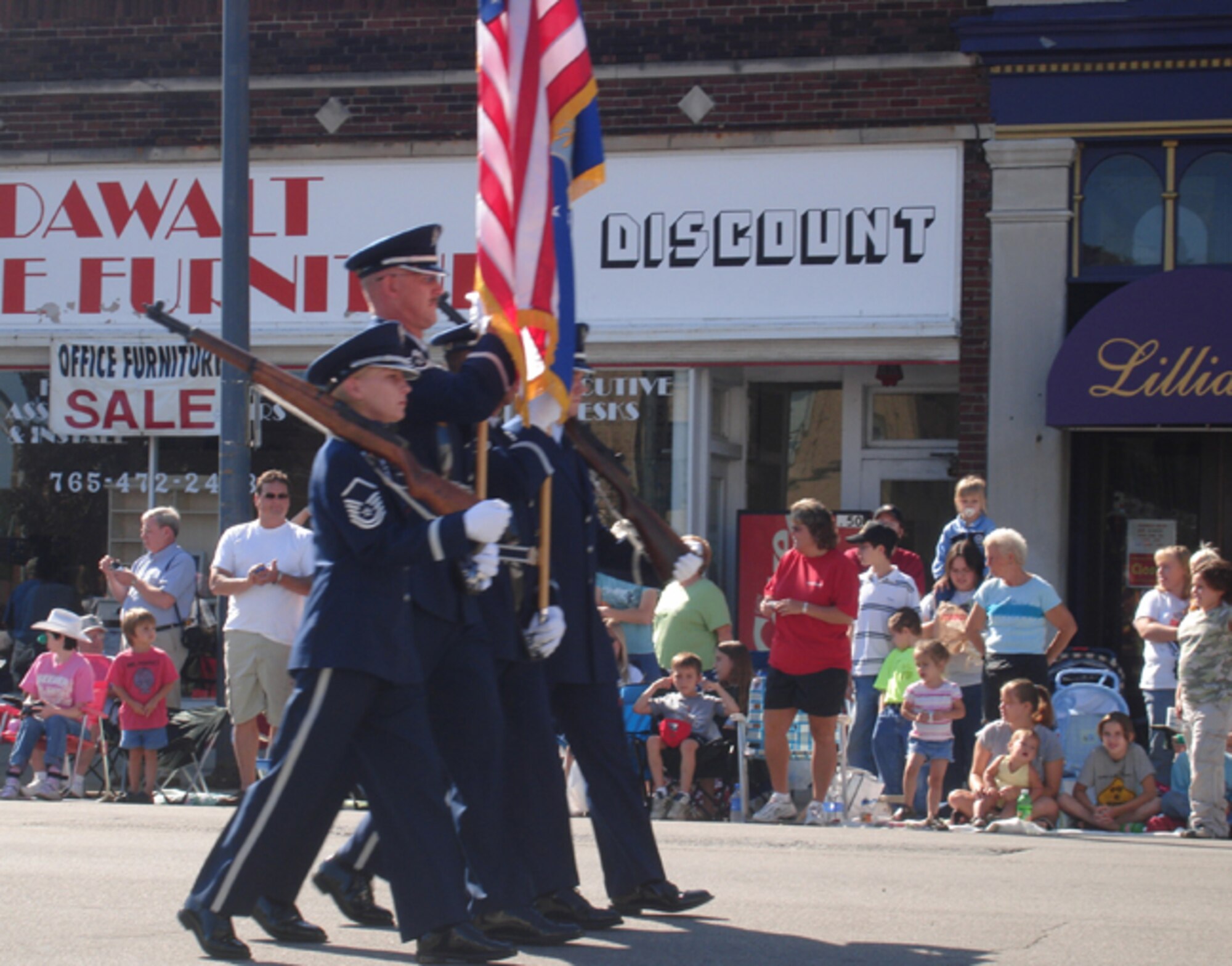 GRISSOM AIR RESERVE BASE, Ind -- Members of the Honor Guard from Grissom ARB proudly walk down the main street of Peru, Ind., during a recent festival parade.  Volunteer members of the Honor Guard are involved in numerous community outreach events each year.  (U.S. Air Force photo)