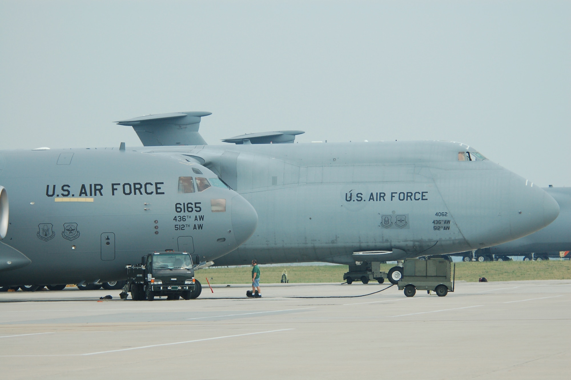 A Dover Air Force Base C-5 Galaxy and C-17 Globemaster III are parked side by side here. Dover is recapitalizing and modernizing its fleet with  13 new C-17s and has fitted all assigned C-5 airframes with the avionics modernization program upgrades. (U.S. Air Force photo/Master Sgt. Steve Marciniak)