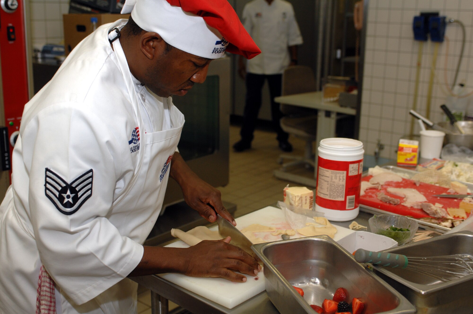 SPANGDAHELM AIR BASE, Germany – Staff Sgt. Jermaine Ireland, 52nd Services Squadron, prepares a dish during the Spangdahlem Air Base Iron Chef competition July 25. Sergeant Ireland has been cooking since he was young when he would hunt and fish then cook what he caught. (U.S. Air Force photo/Airman 1st Class Stephanie Clark)