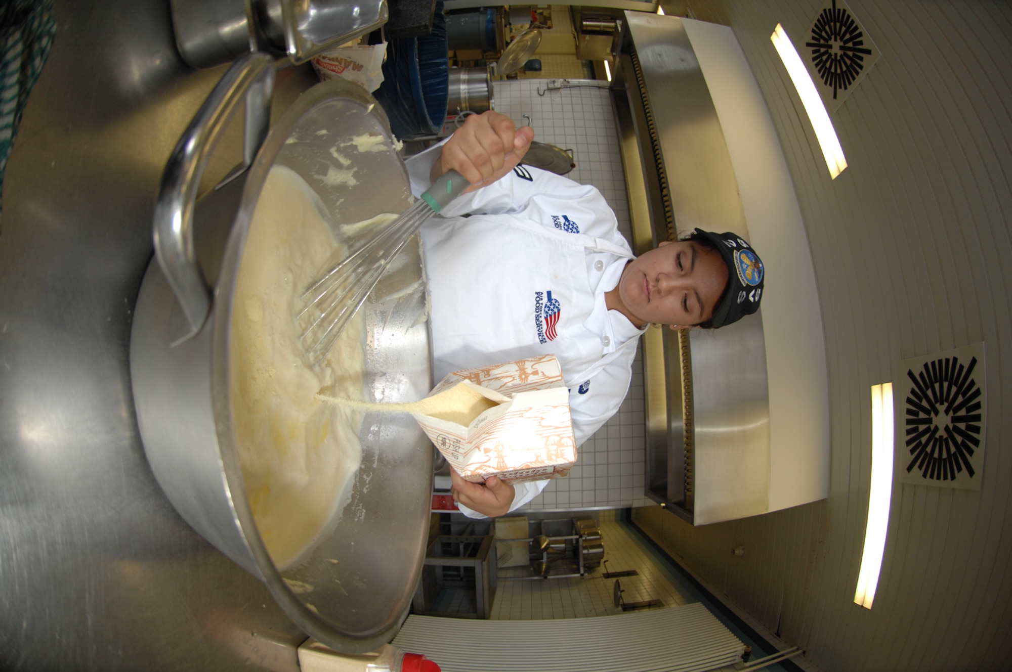 SPANGDAHELM AIR BASE, Germany – Airman 1st Class Lillian Perez, 52nd Services Squadron, stirs ingredients into a bowl during the Spangdahlem Air Base Iron Chef competition July 25. The participants were given a time limit of two hours to create a minimum of two entrees from a bag of unknown ingredients. All ingredients had to be used in some way. (U.S. Air Force photo/Airman 1st Class Stephanie Clark)