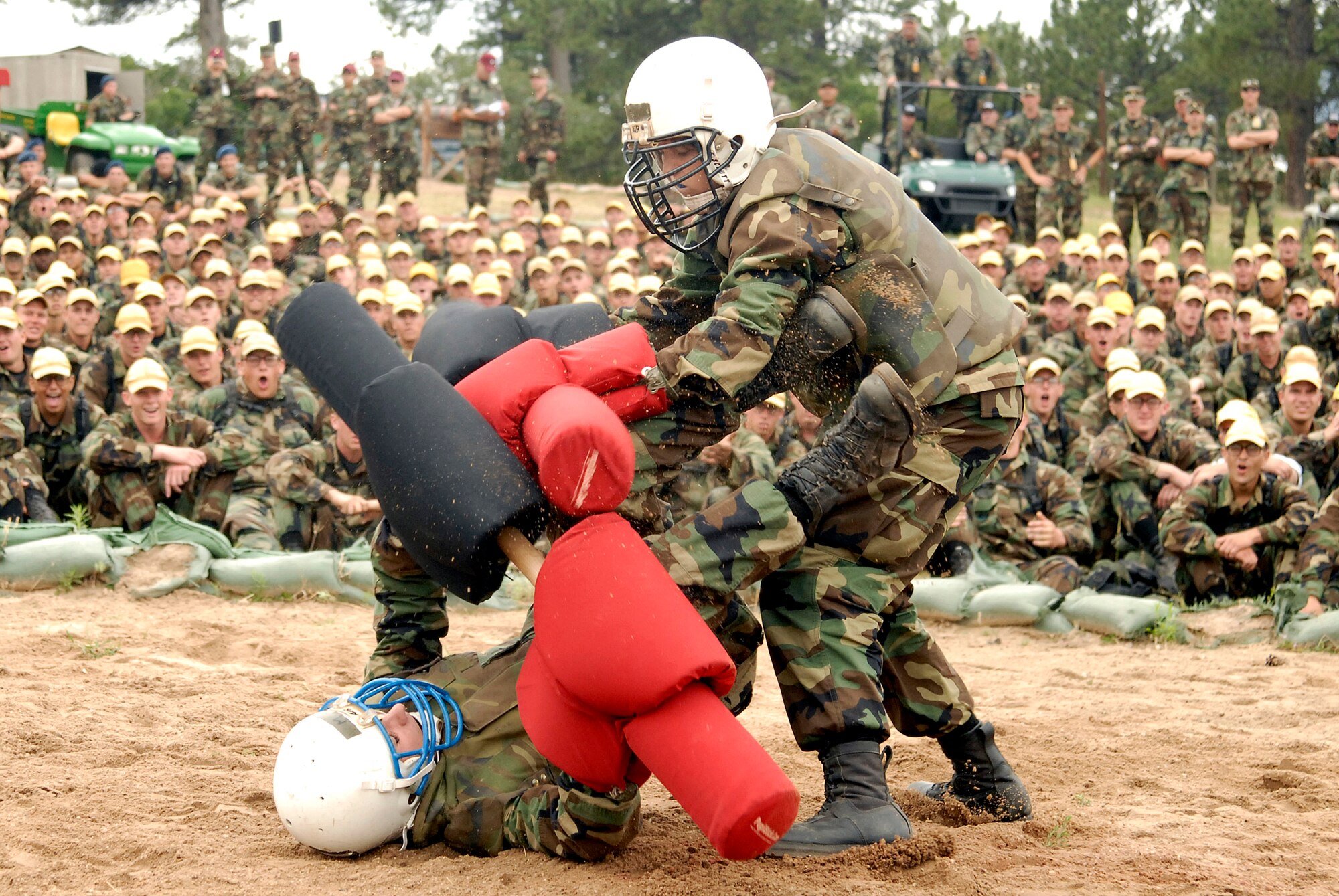 Academy basic cadet trainee Emily Frick (standing) bests her opponent during her semi-final match July 28 at the U.S. Air Force Academy, Colo. She went on to win the title of "Big Bad Basic," a single-elimination tournament where contestants battle one another with pugil sticks.  (U.S. Air Force photo/Mike Kaplan)