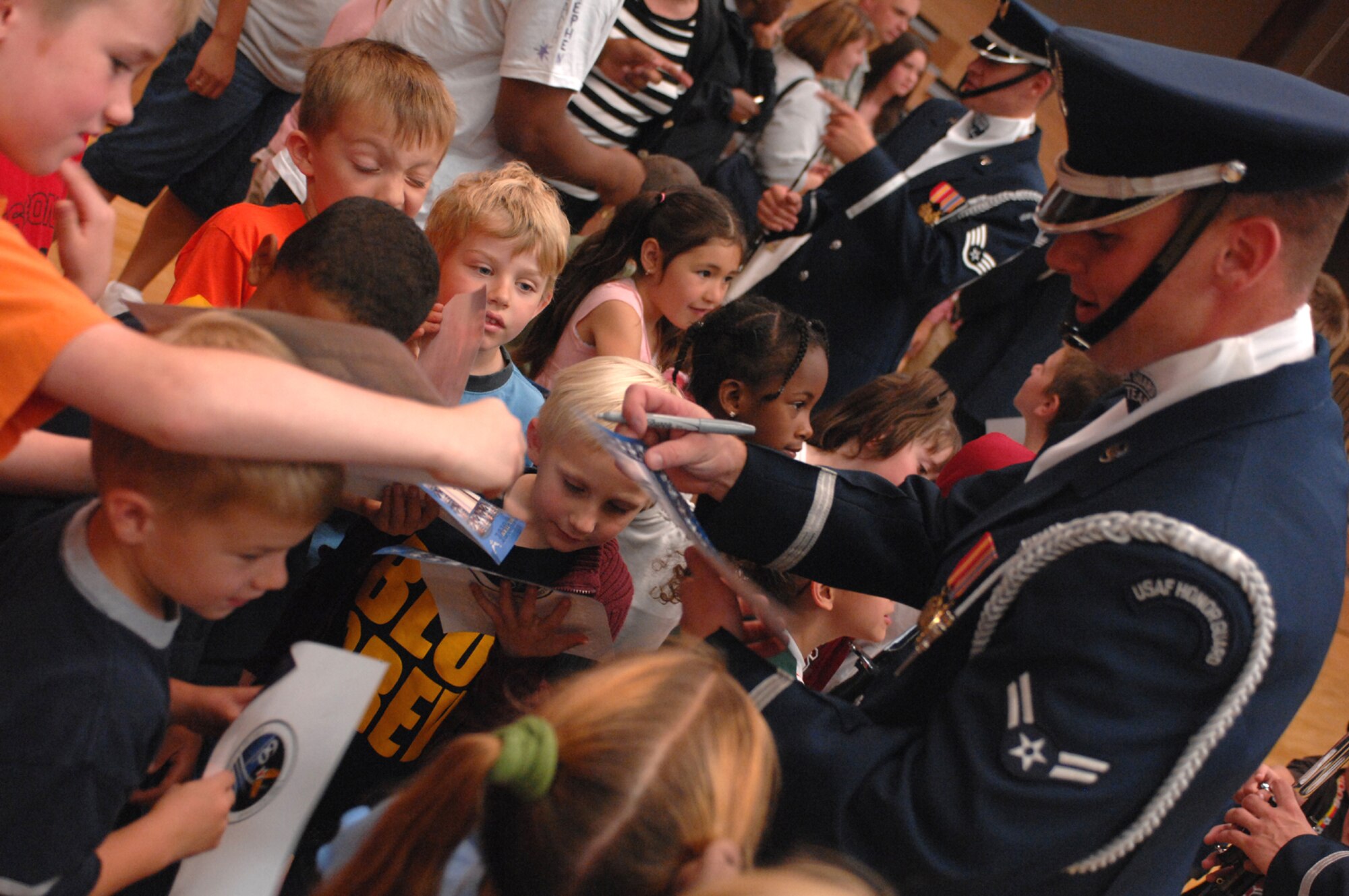 SPANGDAHELM AIR BASE, Germany – Airmen with the Air Force Honor Guard Drill Team, stationed out of Bolling Air Force Base, Washington DC, sign autographs after performing at Spangdahlem Air Base, Germany, Aug. 2. (U.S. Air Force photo/Airman 1st Class Stephanie Clark)