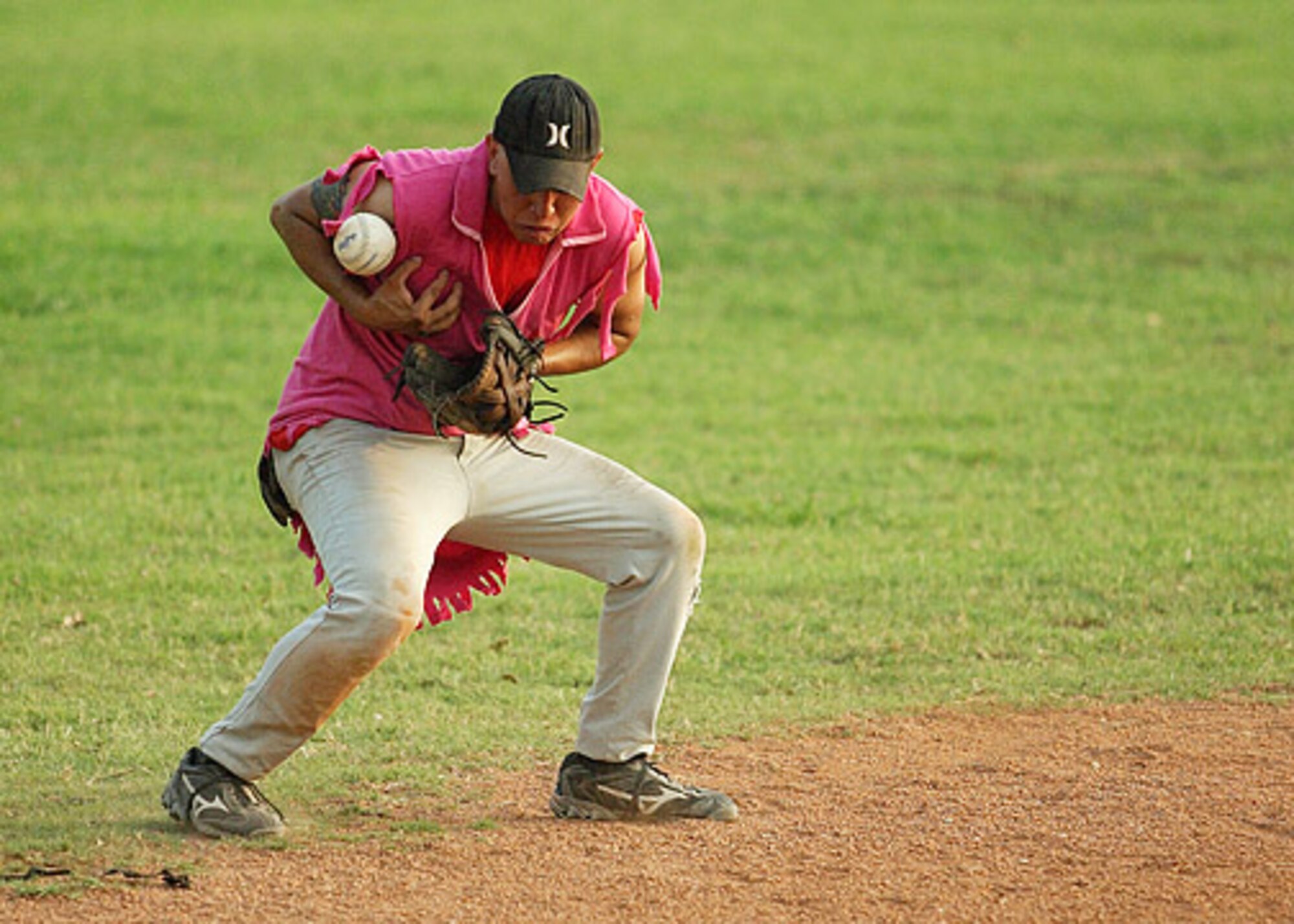 AMMO's Esteban Quintana juggles a ground ball during the first game of the championship.  AMMO went on to win the second game 11-10 over the 728th Air Mobility Squadron. (U. S. Air Force photo by Ismael Gomez)