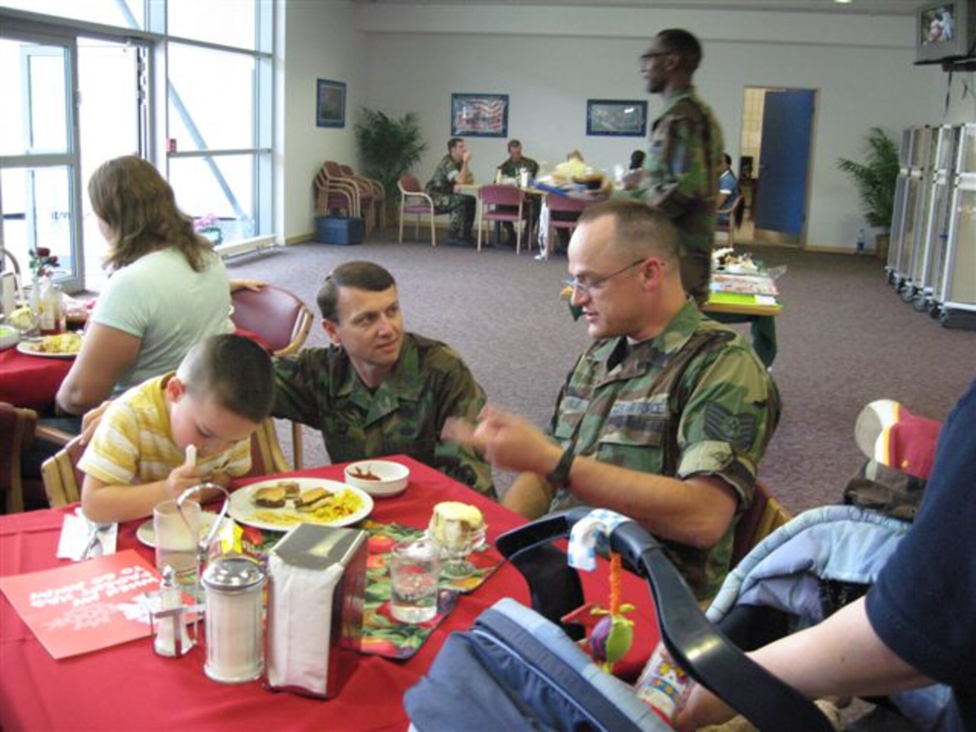 Col. Earl Matthews, 435th Air Base Wing commander, meets and greets families at the Project Care dinner July 26 at the Kapaun Air Station Dining Facility. 