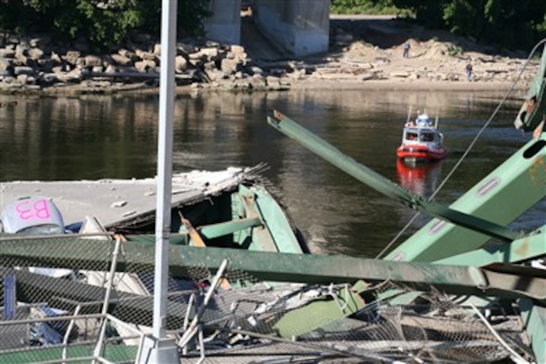 A 25-foot U.S. Coast Guard small boat patrols a safety zone at the bridge collapse site in Minneapolis, Minn., Aug. 2, 2007. The Coast Guard enforced a seven-mile closure of the Mississippi River to support local efforts to search for victims and remove debris from the water. 