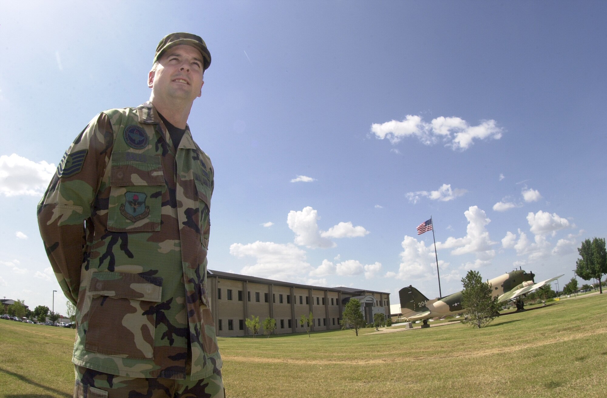 Tech. Sgt. Kelly Bales, a training specialist with the 316th Training Squadron, poses for a photo with the Norma Brown Building in the background. Sergeant Bales received an Air Force Achievement Medal July 25 in recognition for saving a woman’s life. (U.S. Air Force photo by Airman 1st Class Luis Loza Gutierrez)