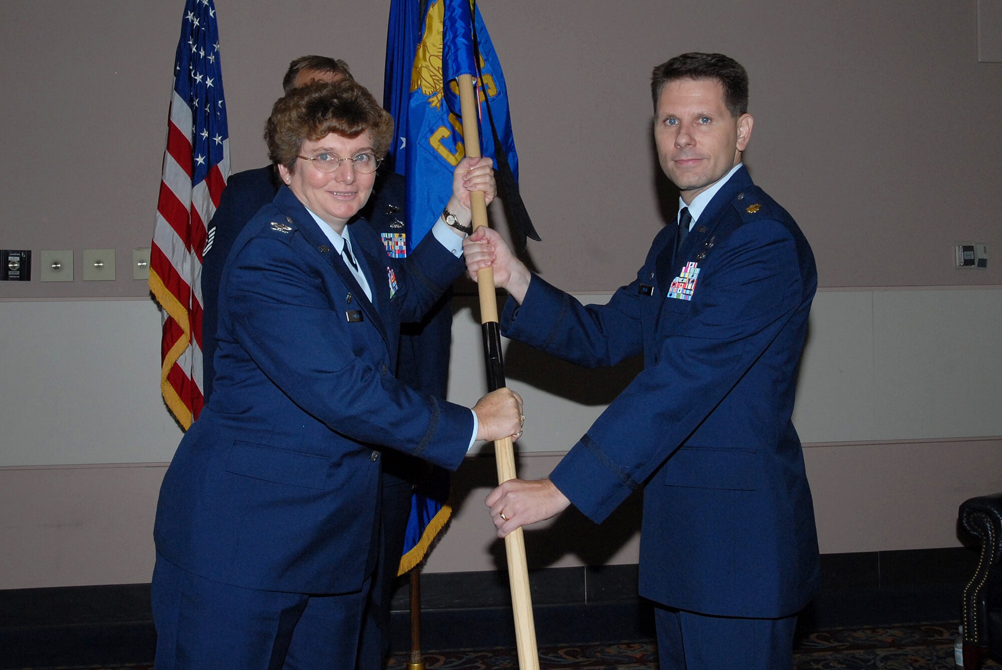 (Left) Col. Ada Conlan, 17th Mission Support Group commander, passes the 17th Mission Support Squadron guidon to Maj. Clinton Ross Monday at the Goodfellow Event Center. Major Clinton replaced Maj. Michael Gayer. (U.S. Air Force photo by Tech. Sgt. Gina O’Bryan)
