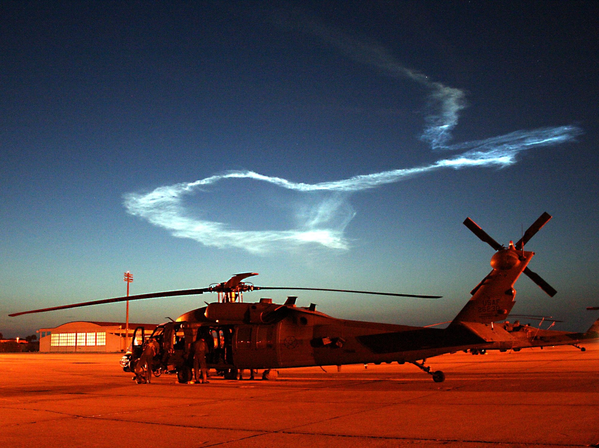 PATRICK AIR FORCE BASE, Fla. -- The crew of a 920th Rescue Wing HH-60G Pave Hawk helicopter conducts post-flight operations after supporting a NASA Delta II rocket launch from Kennedy Space Center just before 5:30 a.m. today. 

Reservists from the 920th are responsible for clearing the Eastern range before all Space Shuttle and rocket launches -- flying off the coast of Kennedy Space Center to ensure no boats are in the launch path. 

The lazy twist of smoke in the early-morning sky is all that remains from the trail left by the rocket, which carried the Phoenix spacecraft on the first leg of its trip to Mars' arctic plain, where a landing craft will dig through the Martian soil and ice to analyze the samples it retrieves. (U.S. Air Force photo/Staff Sgt. Paul Flipse)