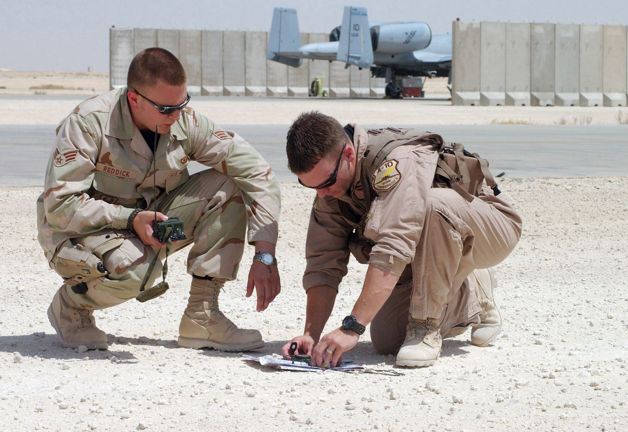 AL ASAD AIRFIELD, Iraq -- Senior Airman Josh Reddick, 190th Expeditionary Fighter Squadron life support technician, reviews maps and search and recovery techniques with Capt. Jason Cobb, 190th EFS A-10 Thunderbolt II pilot. Both Airmen are deployed from the Idaho Air National Guard's 124th Wing, Boise, Idaho. The A-10s here are the only A-10s providing close air support to American and coalition servicemembers supporting Operation Iraqi Freedom in Iraq. (U.S. Air Force photo/1st Lt. Shannon Collins)                               