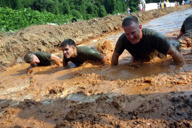 A Marine with Marine Special Operations Advisor Group, U.S. Marine Corps Forces, Special Operations Command does 25 push-ups in the mud during the inaugural Marine Mud Run at Belmont Abbey College, Aug. 4. The event was created to support combat injured Marines, Sailors and their families with Wounded Warrior Battalion-East here. Eight Marines from MSOAG participated in the mud run.