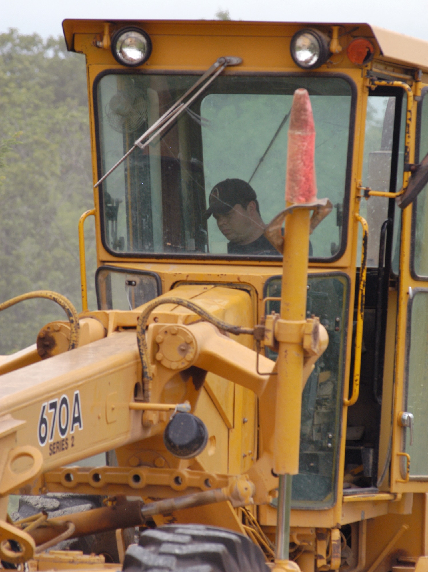 Tech. Sgt. Jason Woodworth, structural craftsman with the Missouri Air National Guard's 131st Fighter Wing Detachment 1, drives a road grader to smooth out one of the many gravel roads at Cannon Range near Ft. Leonard Wood, Mo.  All 11 of the detachment's people are qualified heavy equipment operators despite coming from diverse career fields.  They work as a single team in operating and maintaing this range, which is vital to conducting training for pilots from the Reserve, Guard and active duty. (U.S. Air Force photo/Maj. David Kurle) 