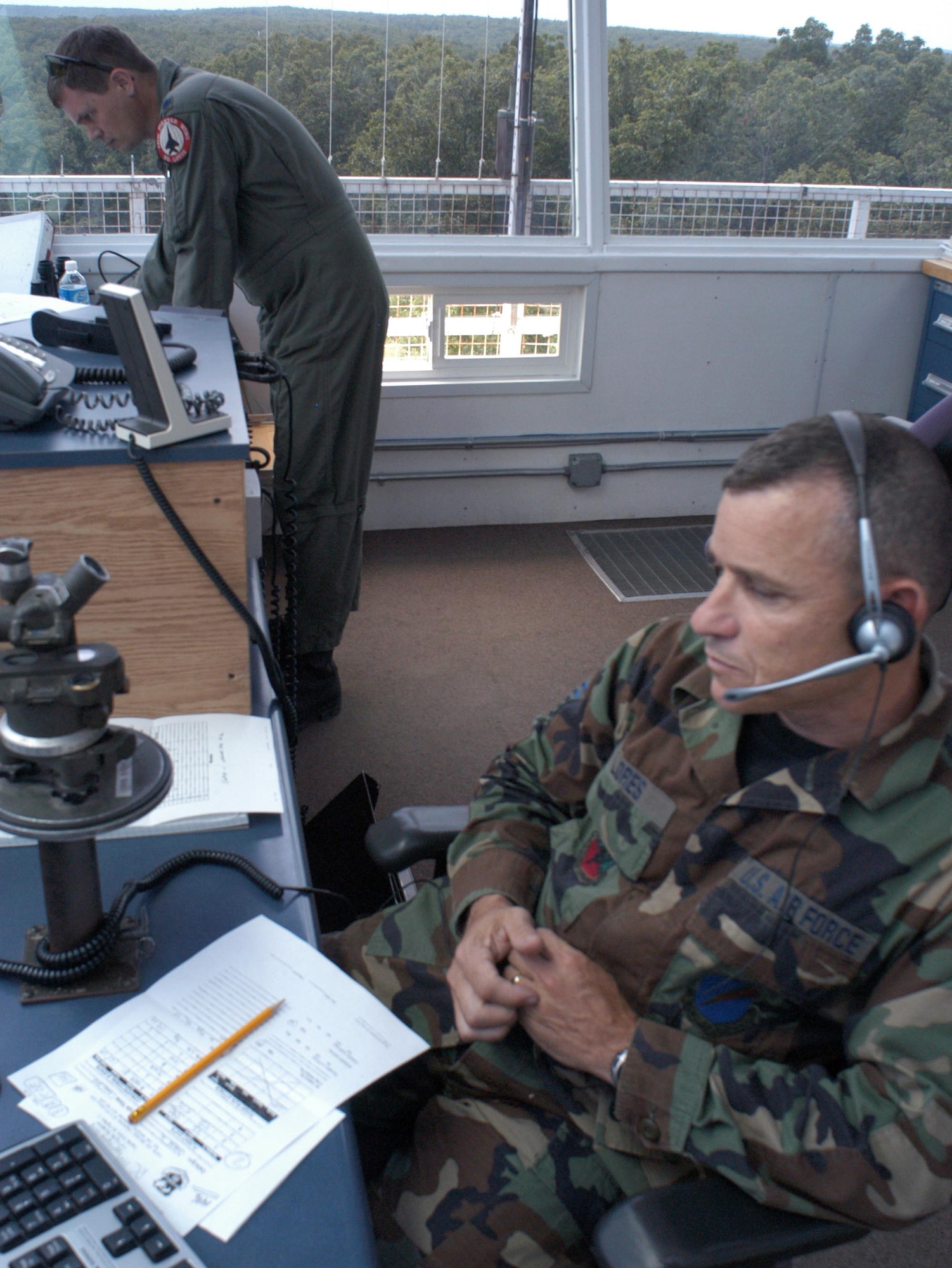 Lt. Col. Scott Porter, left, commander at Cannon Range near Ft. Leonard Wood, Mo., and Senior Master Sgt. Randy Flores, superintendent, control a flight of two F-16s over the range June 20, 2007.  Both Airmen are members of the Missouri Air National Guard's 131st Fighter Wing's Detachment 1.  They are two of the 11 people who manage and operate Cannon Range, which is a vital training resource for combat pilots across the country.  (U.S. Air Force photo/Maj. David Kurle)