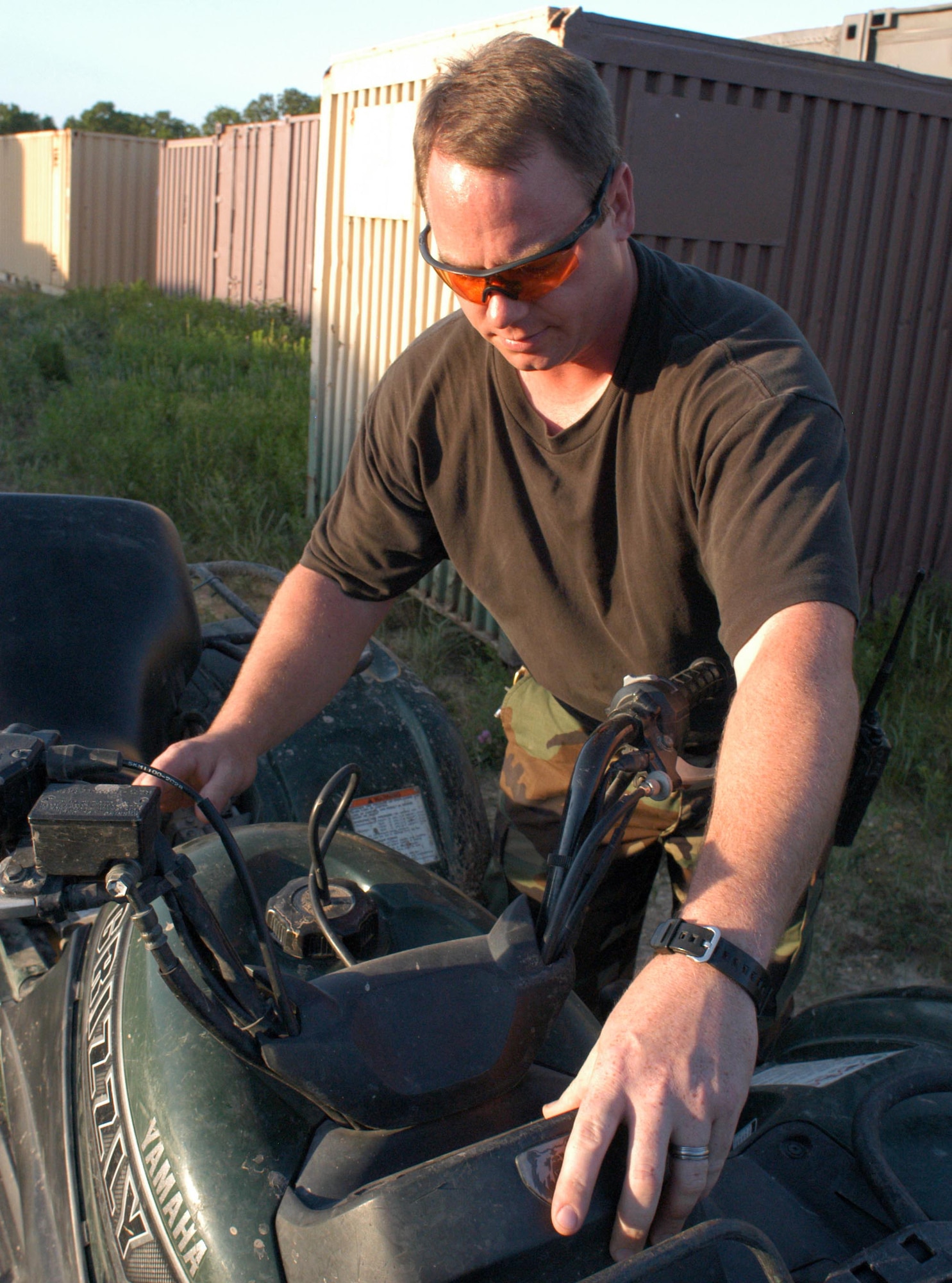 Master Sgt. Tracey Sargent, a mechanic with the Missouri Air National Guard, fixes the idle on a four-wheeler at Cannon Range near Ft. Leonard Wood, Mo., June 19, 2007.  Sergeant Sargent is one of 11 people who manage and operate the range.  The Airmen there represent nine different career fields and have to be proficient in a mulititude of skills to keep the range open for business training Air Force Reserve, Guard and active-duty pilots in attacking ground targets. (U.S. Air Force photo/Maj. David Kurle)