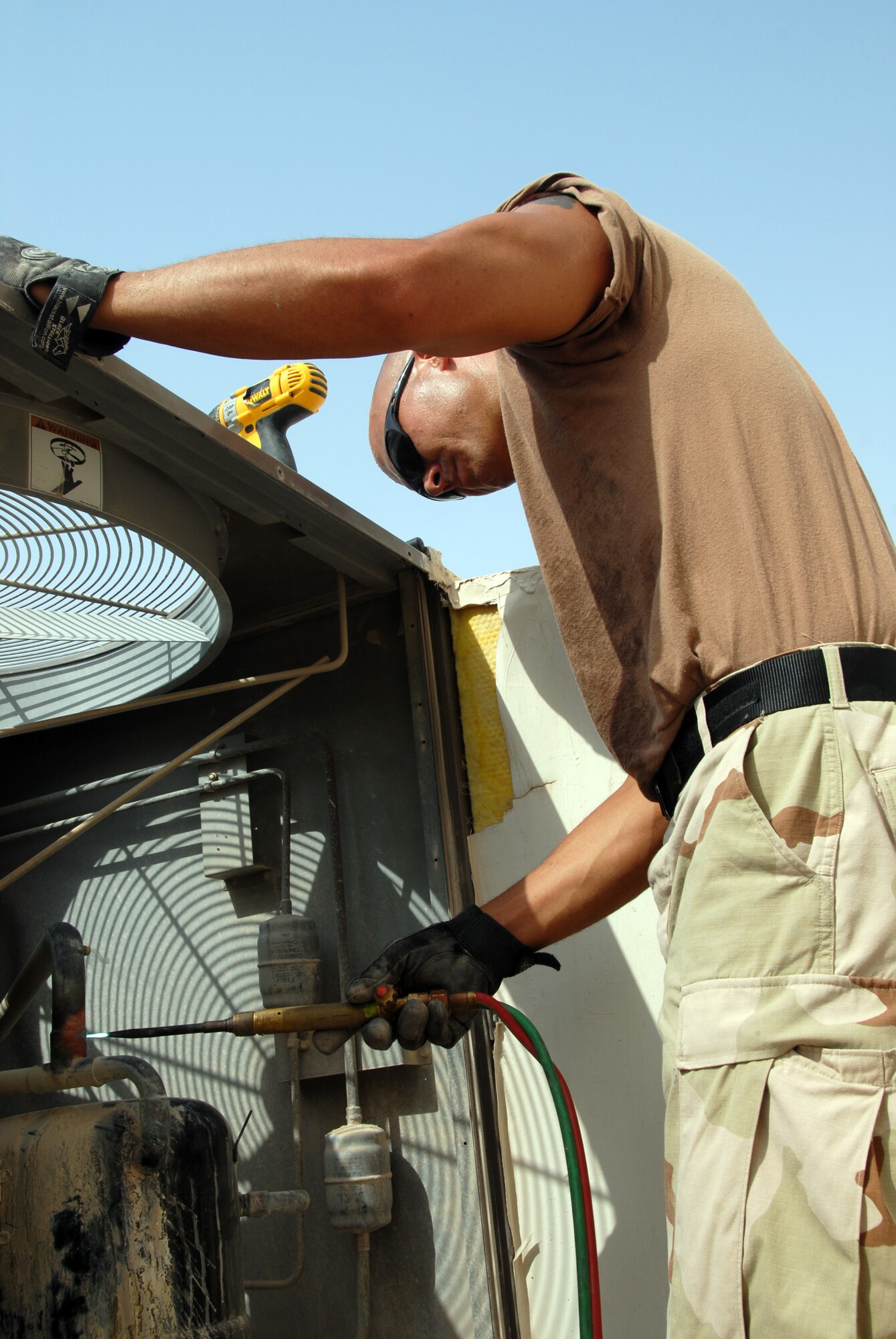 Tech. Sgt. Gary Hughes, with the 379th Expeditionary Civil Engineer Squadron here, troubleshoots an air-conditioner compressor Wednesday.  The heating, ventilation and air conditioning shop responded to more than 1,450 jobs during the rotation’s first month. (U.S. Air Force photo by Airman 1st Class Ashley Tyler)