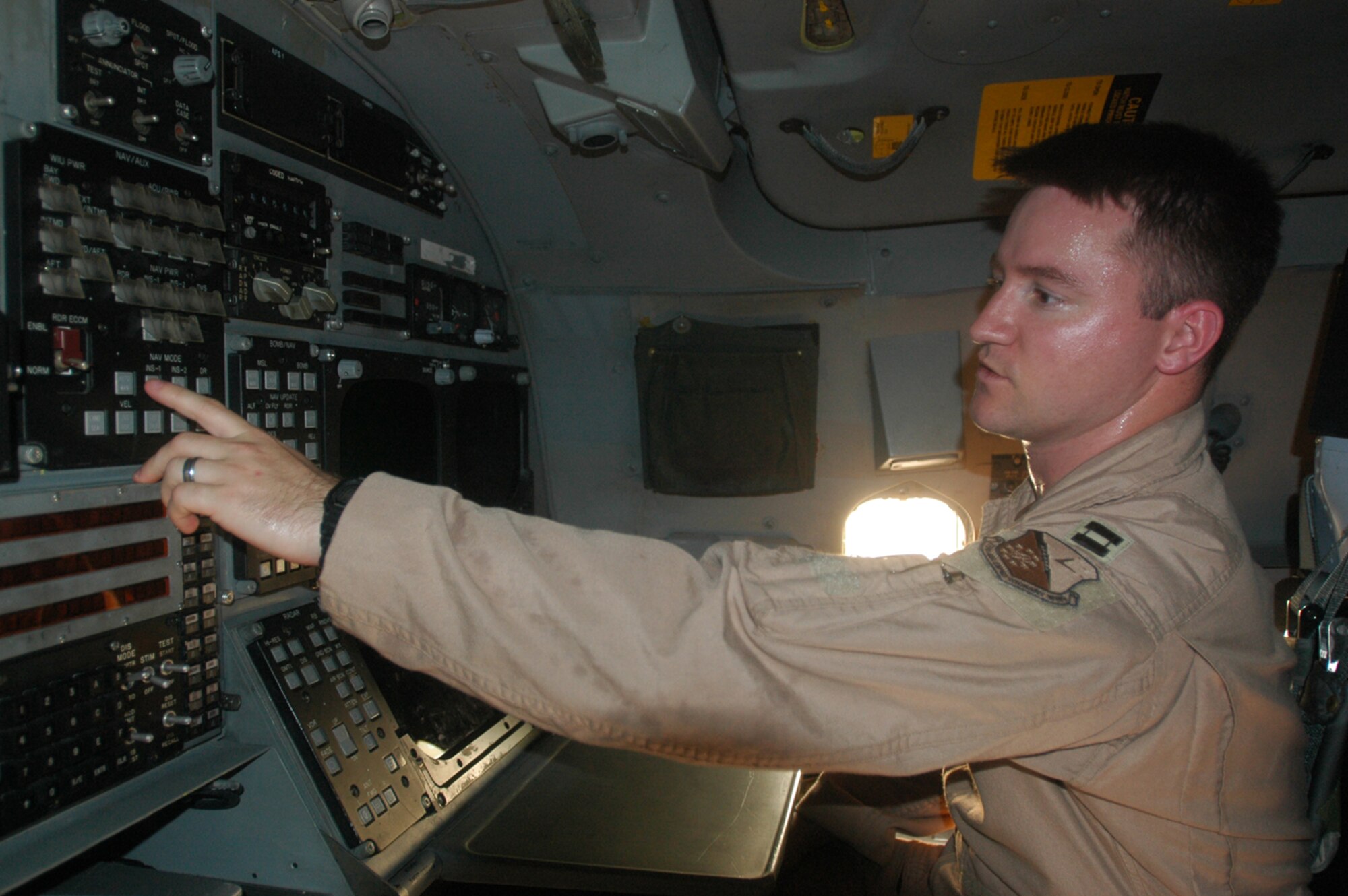 Capt. Matt Steele, 9th Expeditionary Bomb Squadron weapons system officer, explains how he can arm and change a bomb’s coordinates from the flight deck of a B-1B Lancer. Captain Steele arrived here about two weeks ago and has already logged three combat missions, supporting servicemembers on the ground in Operation Enduring Freedom. (U.S. Air Force by Senior Aiman Clark Staehle