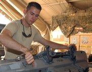 BALAD AIR BASE, Iraq -- Airman 1st Class David Lewis examines an F-16 Fighting Falcon triple ejector rack during a routine inspection of weapon systems in the armament shop at Balad Air Base, Iraq. Airman Lewis, an armament technician assigned to the 332nd Expeditionary Maintenance Squadron, is deployed in support of Operation Iraqi Freedom from Misawa Air Base, Japan. (U.S. Air Force photo/Senior Airman Olufemi A. Owolabi)
