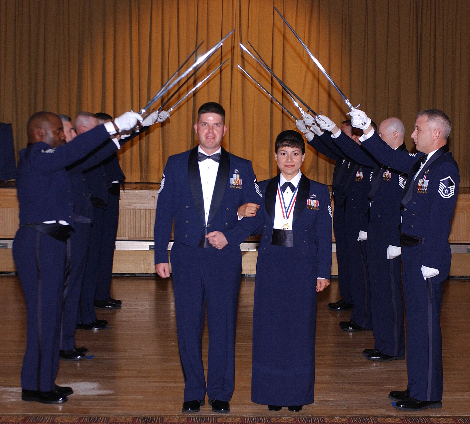 Master Sgt. select Ines Dunsmore, 35 Fighter Wing Noncomissioned Officer in Charge of wing executive information managemnt, is escorted by her husband Master Sgt. Mark Dunsmore, Misawa Security Operations Center, during the Senior Noncomissioned Officer Induction Ceremony.  The ceremony was held August 3, 2007 at the Tohoku enlisted club, Misawa Air Base, Japan. ( U.S. Air Force photo by Airman First Class Benjamin Wilson)