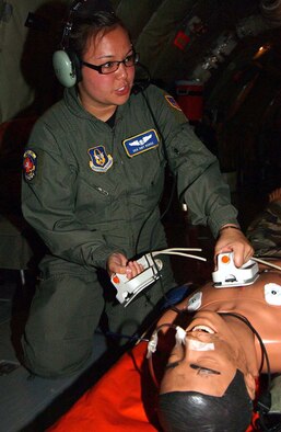 HICKAM AIR FORCE BASE, Hawaii -- Senior Airman Amy Burke, 459th Aeromedical Evacuation Squadron medical technician, practices placement of defibrillator electrode pads onto a medical mannequin during her check ride evaluation July 23. (U.S. Air Force photo/Master Sgt. Shayne Sewell)