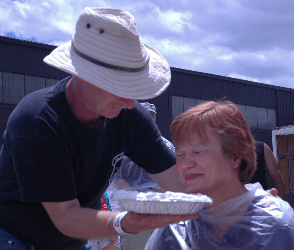 PETERSON AIR FORCE BASE, Colo. -- Master Sgt. Clark Power, 39th Aerial Port Squadron NCO in charge of special handling, pays tribute to his first sergeant, Master Sgt. Sylvia Budinich, with a pie in her face during 302nd Airlift Wing Family Day Aug. 4. (U.S. Air Force photo/1st Lt. Jody Ritchie)