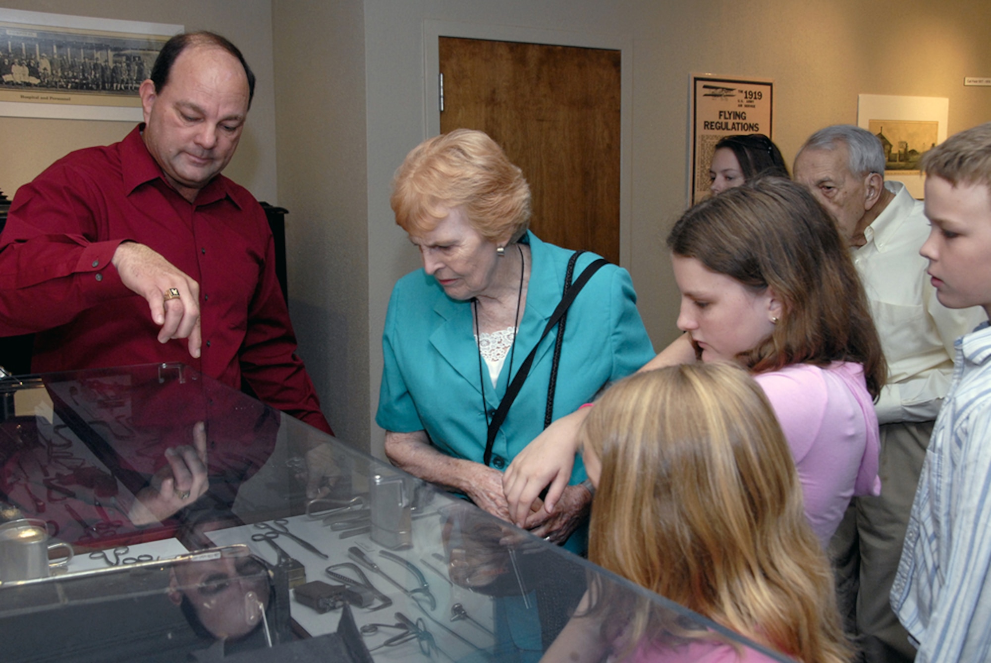 George Strader, historian with the base heritage center, gives a tour of the center to Mrs. Mary Hall and her family Aug. 3. (U.S. Air Force photo/Sandy Wassenmiller)